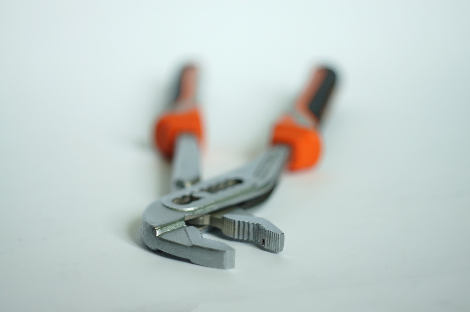 Orange-handled pincers.