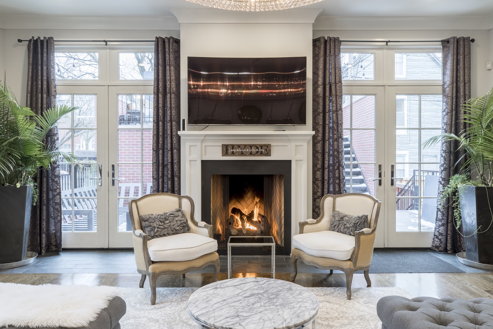 A living room with a fireplace at its centre.