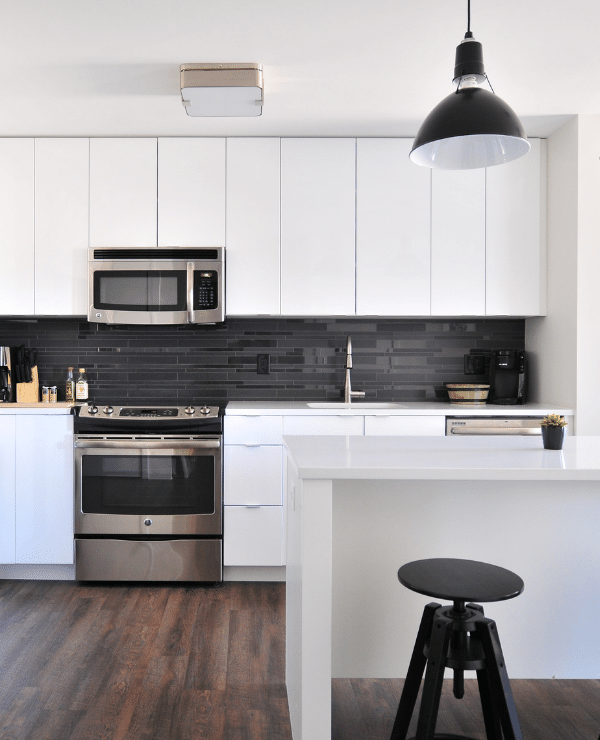 white cabinetry and counters in modern kitchen