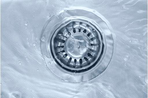 Water flowing down a sink drain.